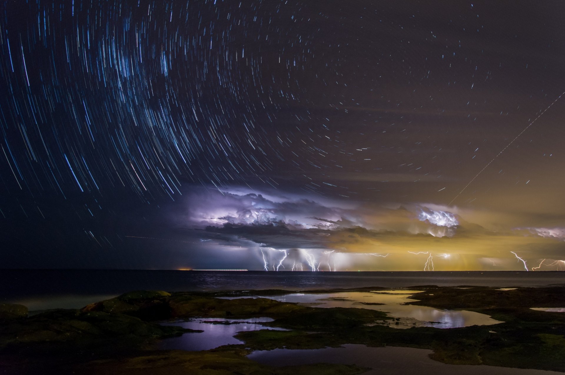 australia queensland town caloundra night sky milky way extract storm clouds lightning light around island moriton the world s third velechenk sandy island sand island sea ocean water bay