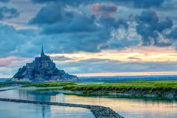 A beautiful castle in the distance against the background of clouds