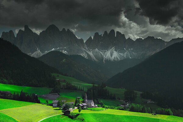 Green valley on the background of mountains in the Alps