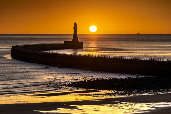 Lighthouse at sunset of the sea