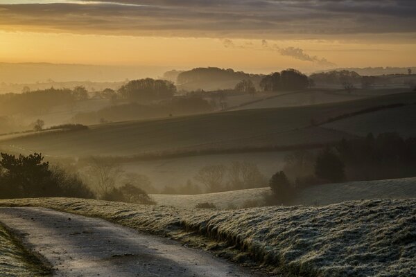 Rural road and hills at sunset