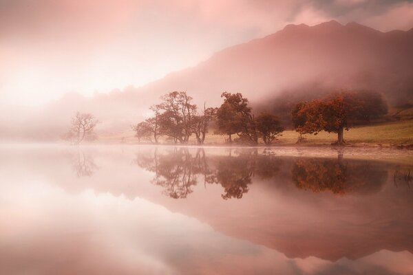 Pink fog on a lake in the mountains