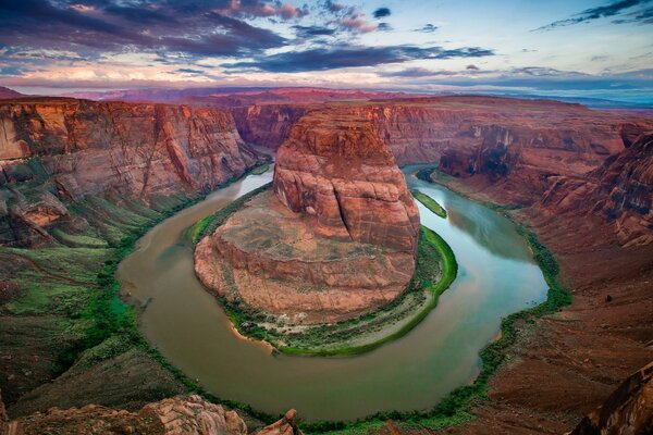 The river wraps around the rock in the canyon