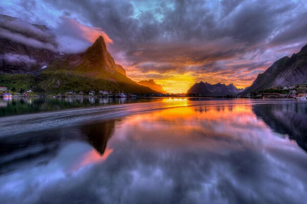 Calm sea on the background of clouds and mountains