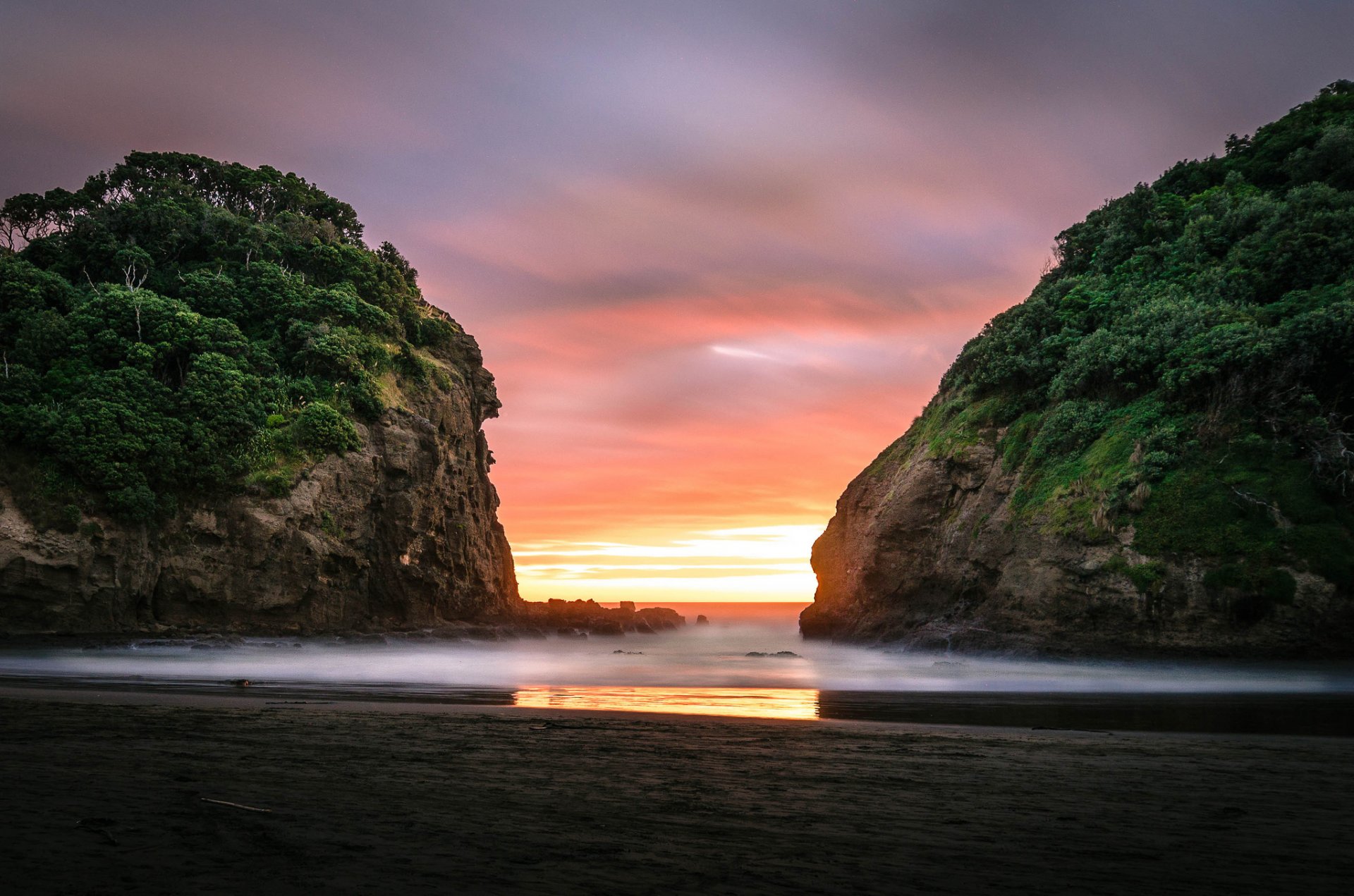 bethells beach auckland nz dawn beach rock ocean