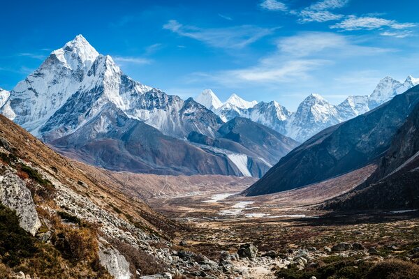 Huge snowy mountains can be seen against the background of the valley