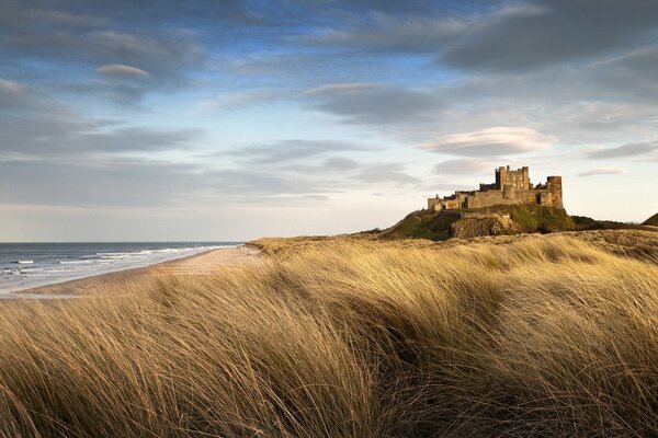 Windy sunset on the shore near the castle