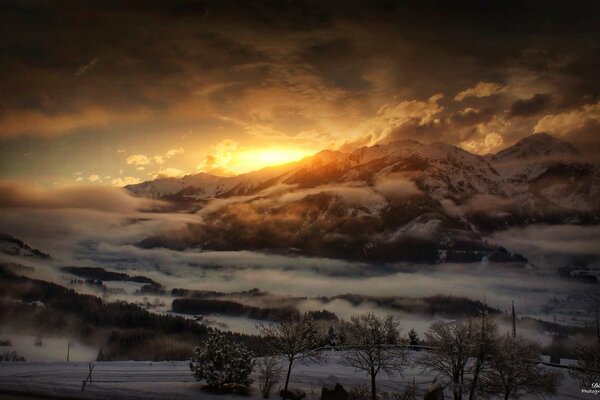 Sunset view from the tops of snowy hills