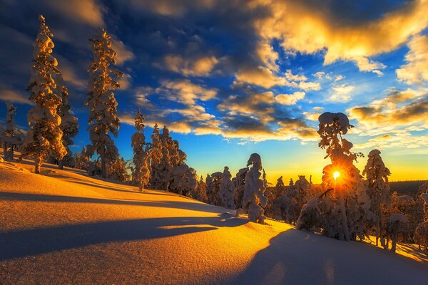 Winter mountain with orange snow from the sun s rays