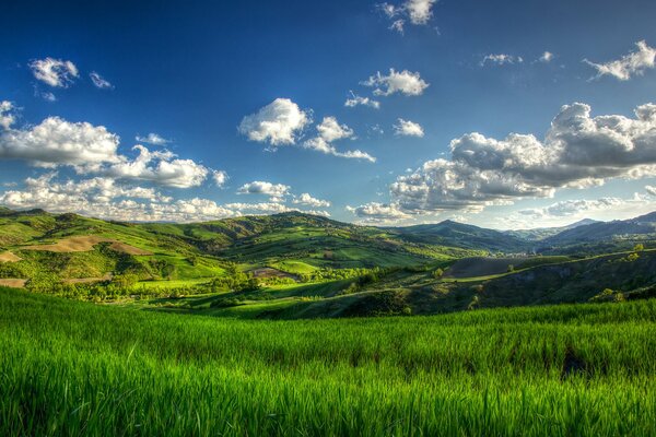 Hills in summer landscape under clouds