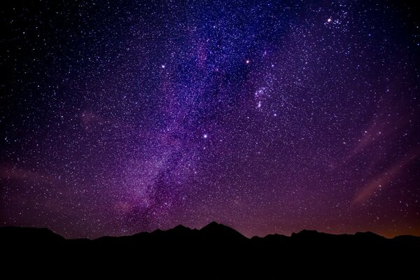 La vía láctea es visible en el cielo nocturno en las montañas