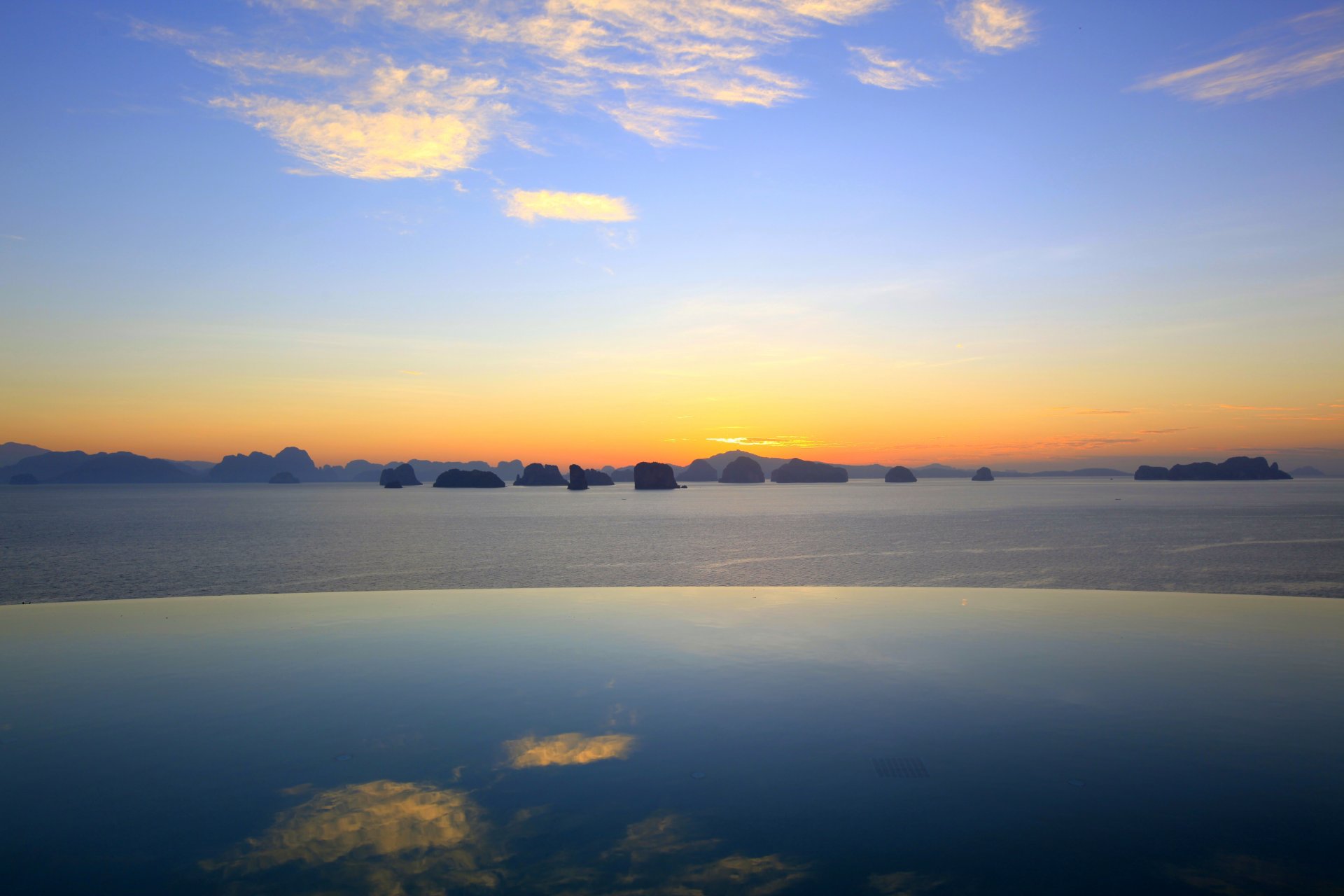 pool water mountain rock sky clouds horizon