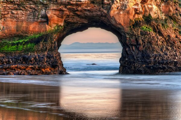 Sea. beach. arch in the rock