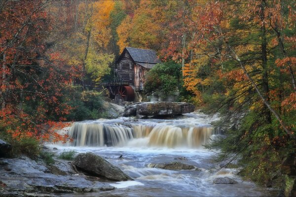 Watermill in the middle of the autumn forest