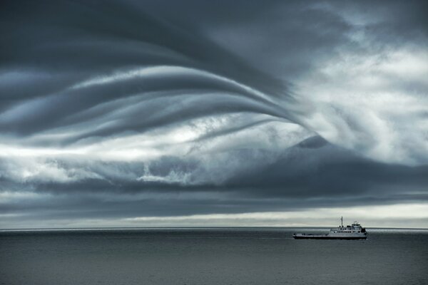 A ferry driven by a storm accompanied by gray clouds