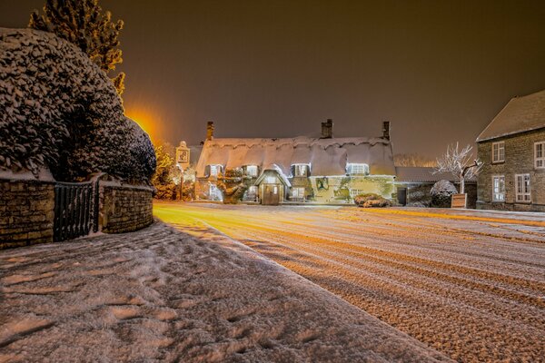 Snow-covered road near the village in winter