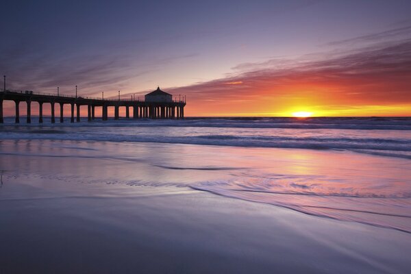 Pier on the ocean at sunset