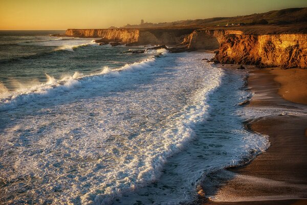 Seashore, sunset waves