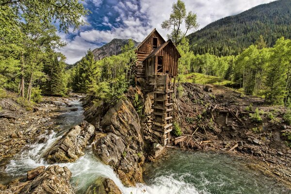 The old mill on the top of the mountain near the waterfall
